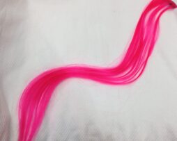 Small synthetic pink clip - on hair piece